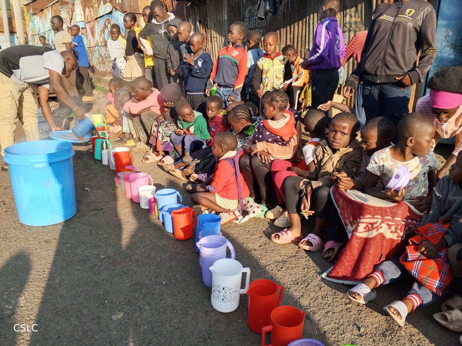 A row of colorful cups and pitchers being filled with porridge for kids