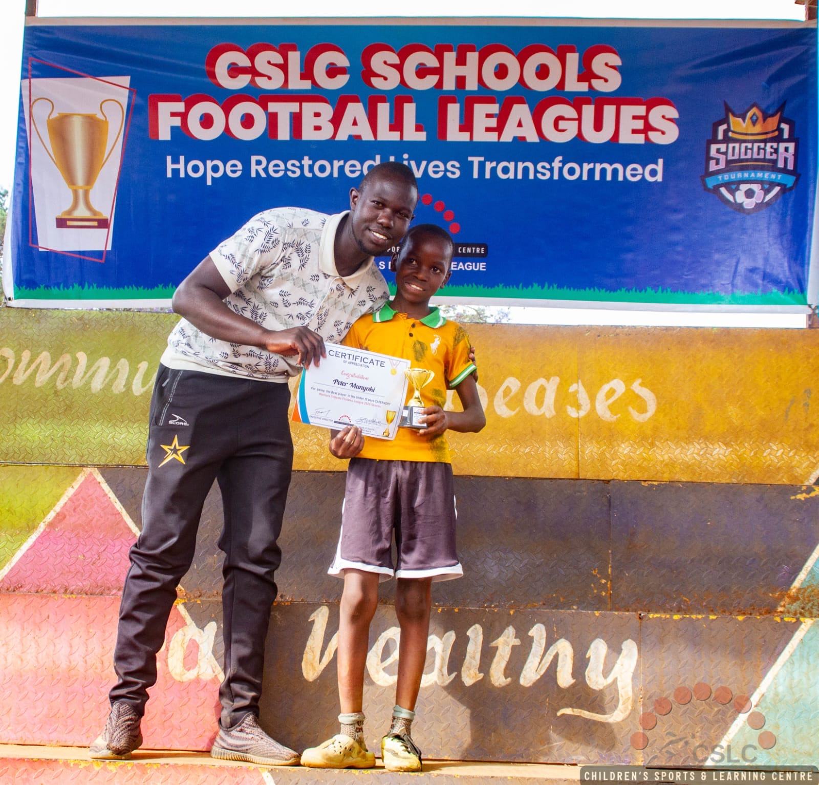 A coach presenting a certificate and trophy to a young player
